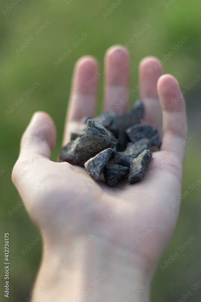 hand holding a stone hand holding a stone
