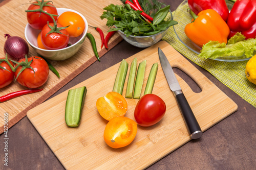 Vegetables for cooking healthy vegetarian vegan diet food. Cutting vegetables on wooden board on kitchen 