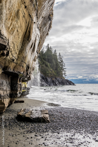 Waterfalls, steep cliffs and waves on the coast at Juan De Fuca Provincial Park on Vancouver Island pacific ocean