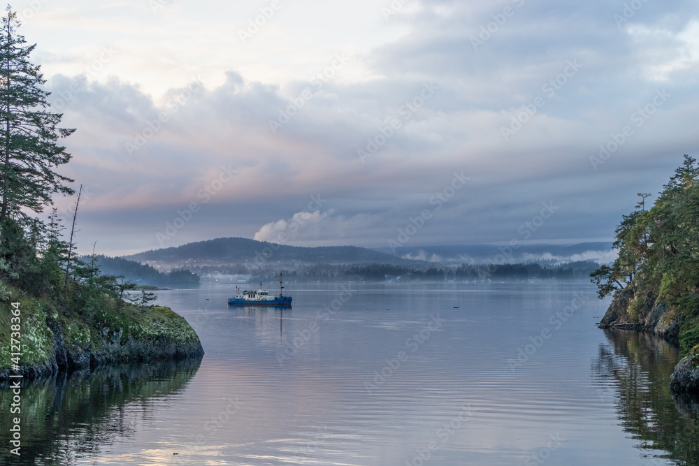 Trawler at anchor in a calm bay at Roche Cove, Sooke, British Columbia Trawler at anchor in a calm bay at Roche Cove, Sooke, British Columbia