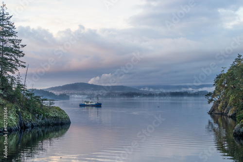 Trawler at anchor in a calm bay at Roche Cove, Sooke, British Columbia © Lynda