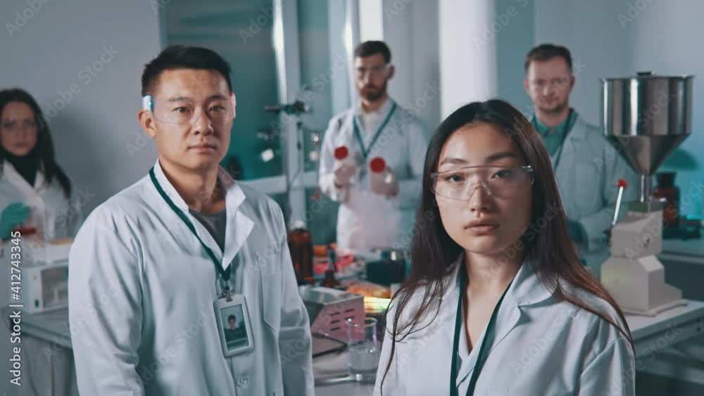 Portrait of team research scientists standing look at camera in modern laboratory. Professional worker. Medical concept. Chemistry. Science. Background team work. Pharmacy, microbiology, industry
