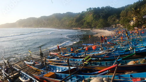 Fishing boats leaning on the shore