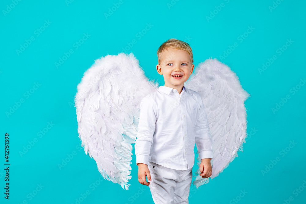 Small cute baby boy with blonde long with white angel wings. Small cute baby boy with blonde long with white angel wings.