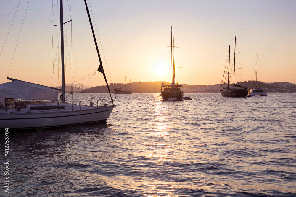 Sunset over a marina in Bodrum, Turkey. Luxury summer adventure, active vacation in Aegean and Mediterranean sea, Turkey.