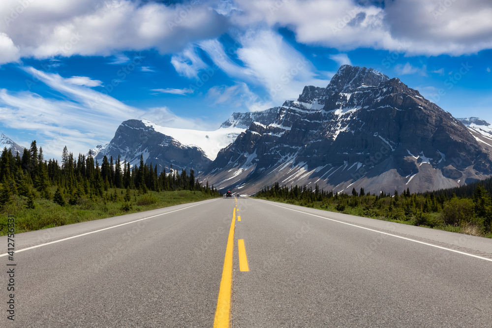 Fototapeta premium Scenic road in the Canadian Rockies. Blue Colorful Sky Art Render. Taken in Icefields Parkway, Banff National Park, Alberta, Canada. Panorama Background