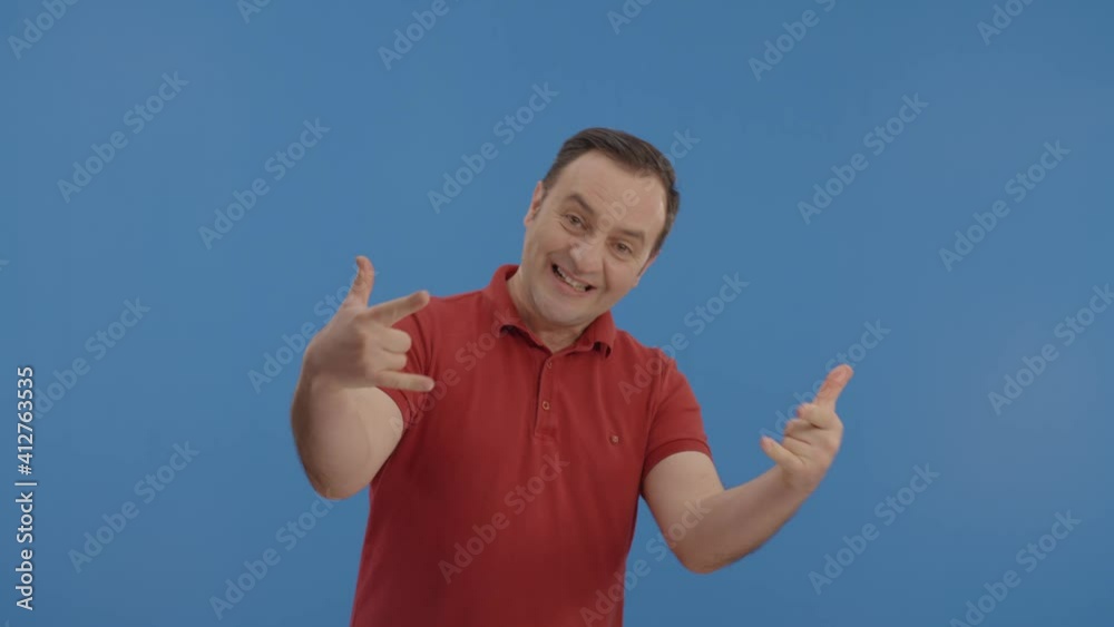 Young man making the rocker sign.Happy rocker man looking with devil ...