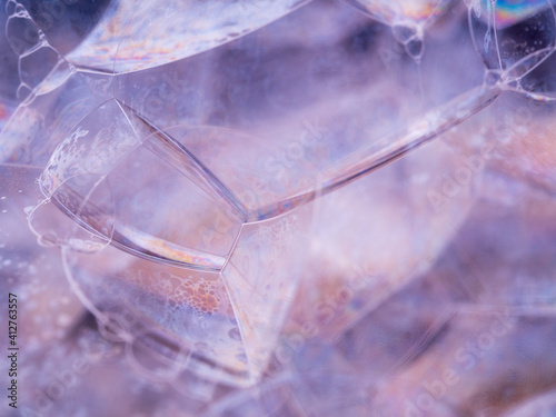 Extreme close up soap bubbles. Rainbow gradient on sides. Close-up view with soft focus. Macro shot.