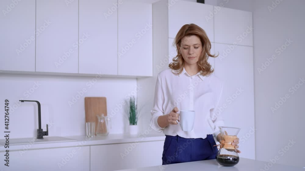 adult caucasian woman drinking pour over coffee businesswoman at home in the morning adult caucasian woman drinking pour over coffee businesswoman at home in the morning