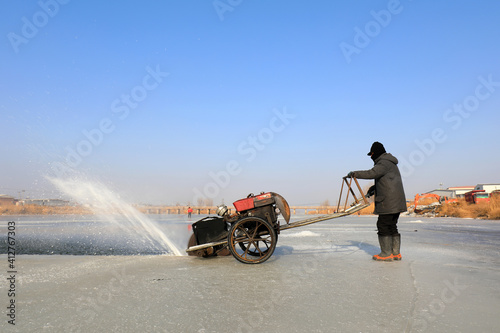 Wallpaper Mural Farmers use electric saws to cut river ice in the wild. Torontodigital.ca