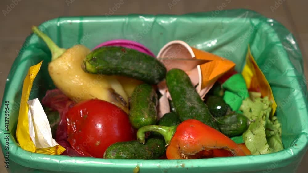 Throwing away food. Uneaten spoiled vegetables are thrown in the trash