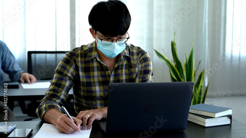 Coronavirus Office workers with mask for corona virus pandemic in the world working in office after lockdown but business must be continuous.