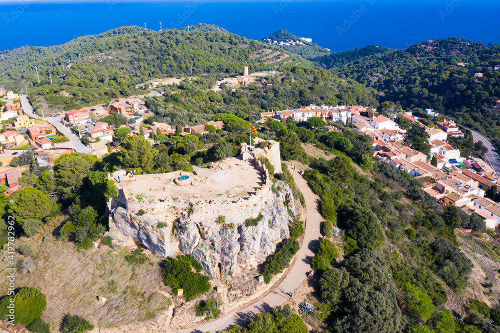 Scenic view from drone of remains of medieval castle on hilltop in coastline Spanish township of Begur, Catalonia