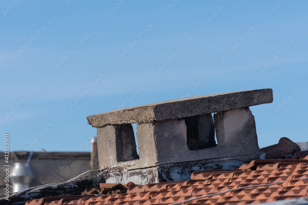 Naklejka premium old concrete chimney on the roof, ruined air duct,