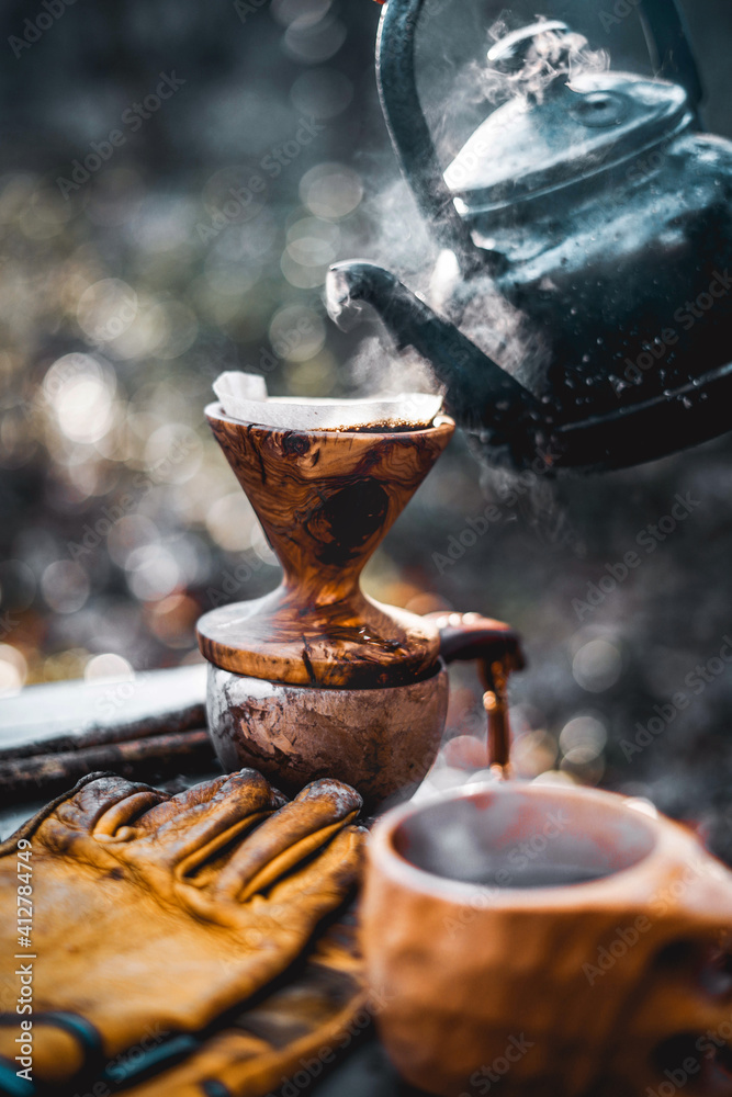 Coffee break with drip coffee on the forest, ground coffee on the filter paper and wood dripper Coffee break with drip coffee on the forest, ground coffee on the filter paper and wood dripper