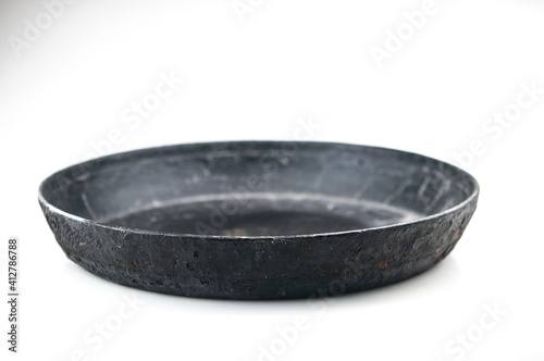 old cast iron frying pan on white background