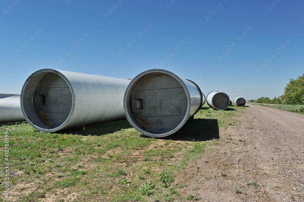 Zhambyl region, Kazakhstan - 05.15.2013 : New parts of wind turbines are laid out in an open field for subsequent assembly Zhambyl region, Kazakhstan - 05.15.2013 : New parts of wind turbines are laid out in an open field for subsequent assembly