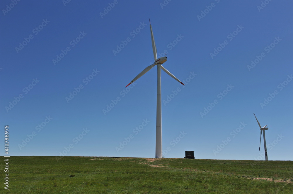 Zhambyl region, Kazakhstan - 05.15.2013 : Wind turbines located in an open hilly area to collect energy. Zhambyl region, Kazakhstan - 05.15.2013 : Wind turbines located in an open hilly area to collect energy.
