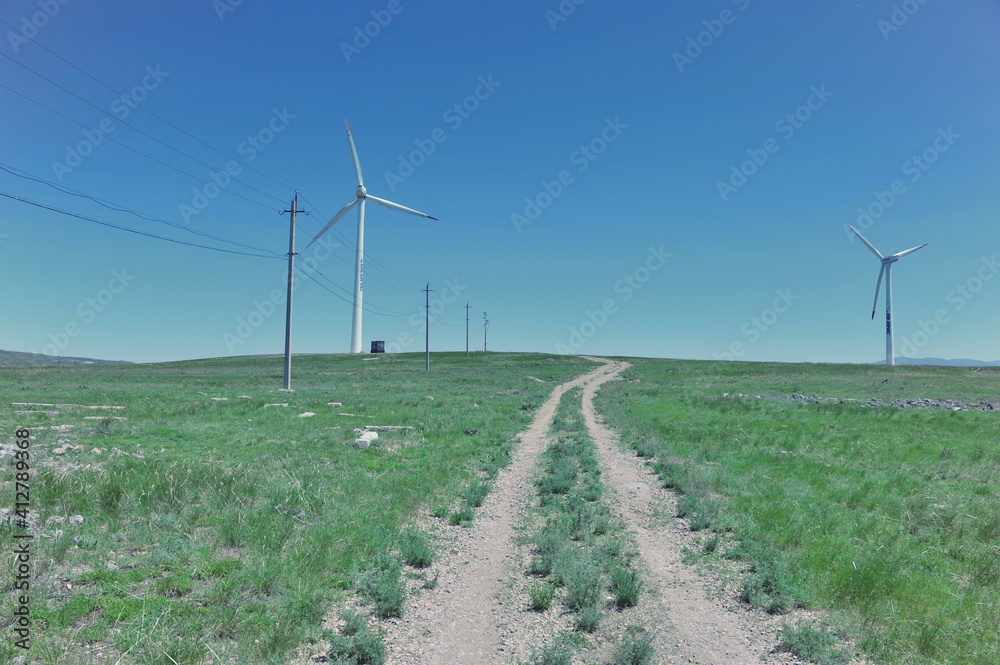 Zhambyl region, Kazakhstan - 05.15.2013 : Wind turbines located in an open hilly area to collect energy.