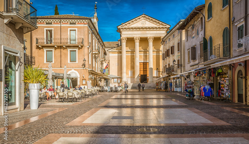 Fototapeta Naklejka Na Ścianę i Meble -  Bardolino on Garda lake. Street of the famous picturesque Village. The town is a popular holiday destination. Bardolino, Verona province, northern Italy - october 29, 2020