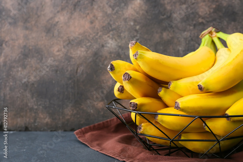 Tasty bananas on dark background photo