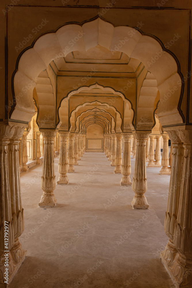 Colonnade Passageway with arched pillars at Hall of Mirrors (Sheesh Mahal) at Amer Palace, Amber Fort, Jaipur, Rajasthan, India,