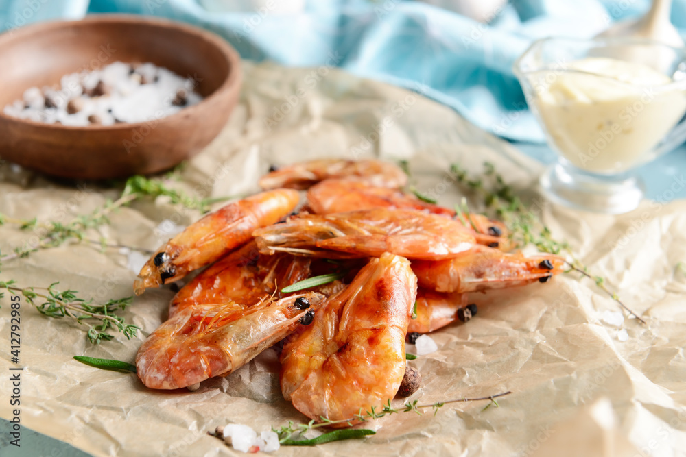 Parchment with tasty shrimps on color background, closeup Parchment with tasty shrimps on color background, closeup