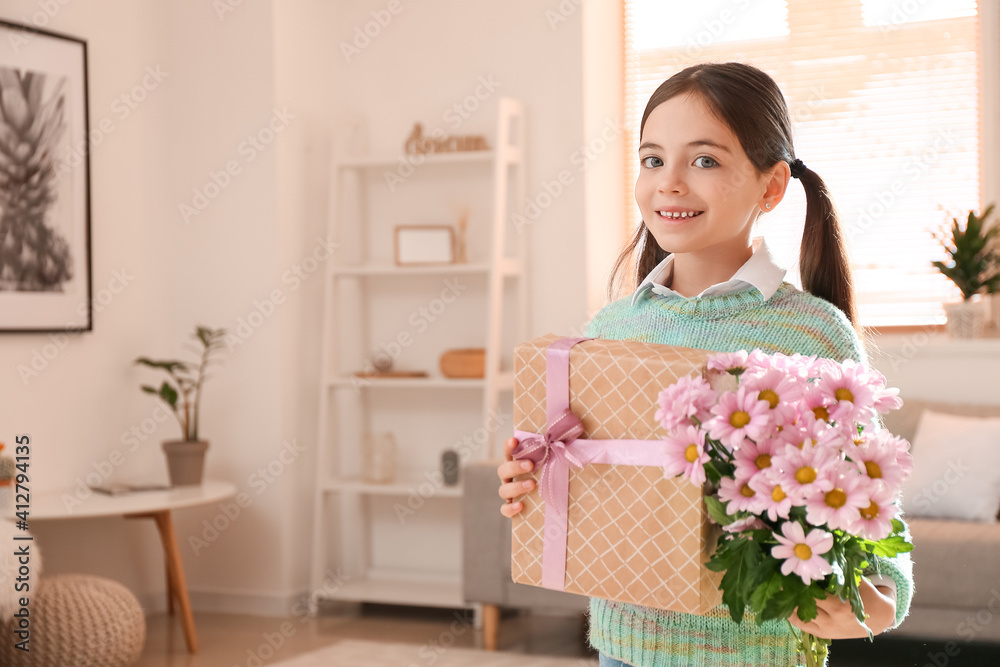 Cute little girl with bouquet of beautiful flowers and gift at home