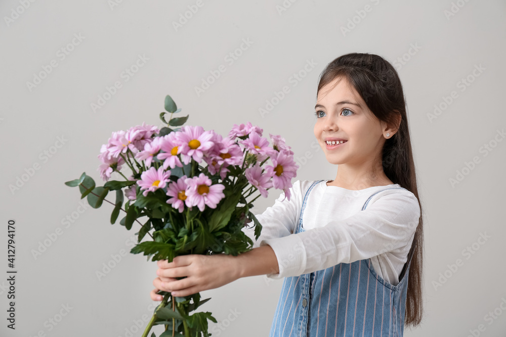 Cute little girl with bouquet of beautiful flowers on grey background Cute little girl with bouquet of beautiful flowers on grey background