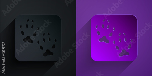 Paper cut Fox paw footprint icon isolated on black on purple background. Paper art style. Vector.