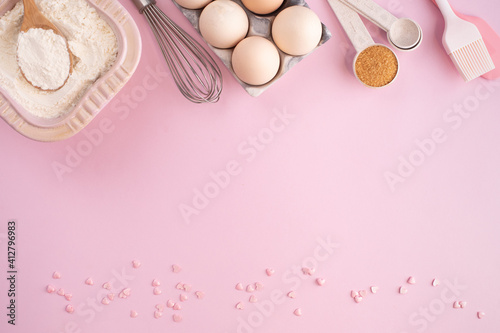 Frame of food ingredients for baking on gently pink pastel background. Cooking flat lay with copy space. Top view. Baking concept. flat lay