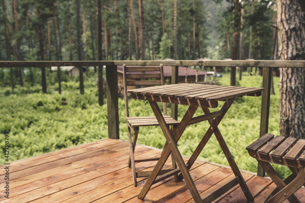 Wooden furniture on the terrace of glamping