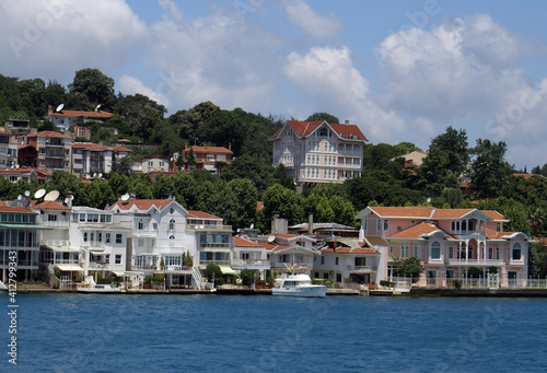 A view from Istanbul`s Bosphorus white mansion under the cloudy sky. The mansion is placed inside the forests. Istanbul has mansions like that along its seashore.