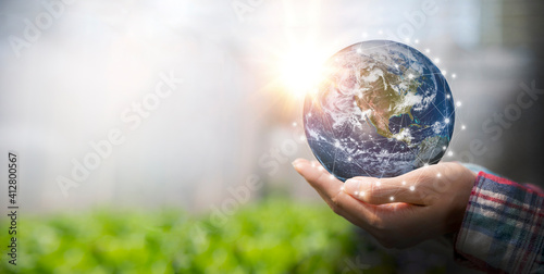 Fototapeta Naklejka Na Ścianę i Meble -  Woman holding earth in her hand, save the earth and energy concept. Earth image courtesy of NASA.