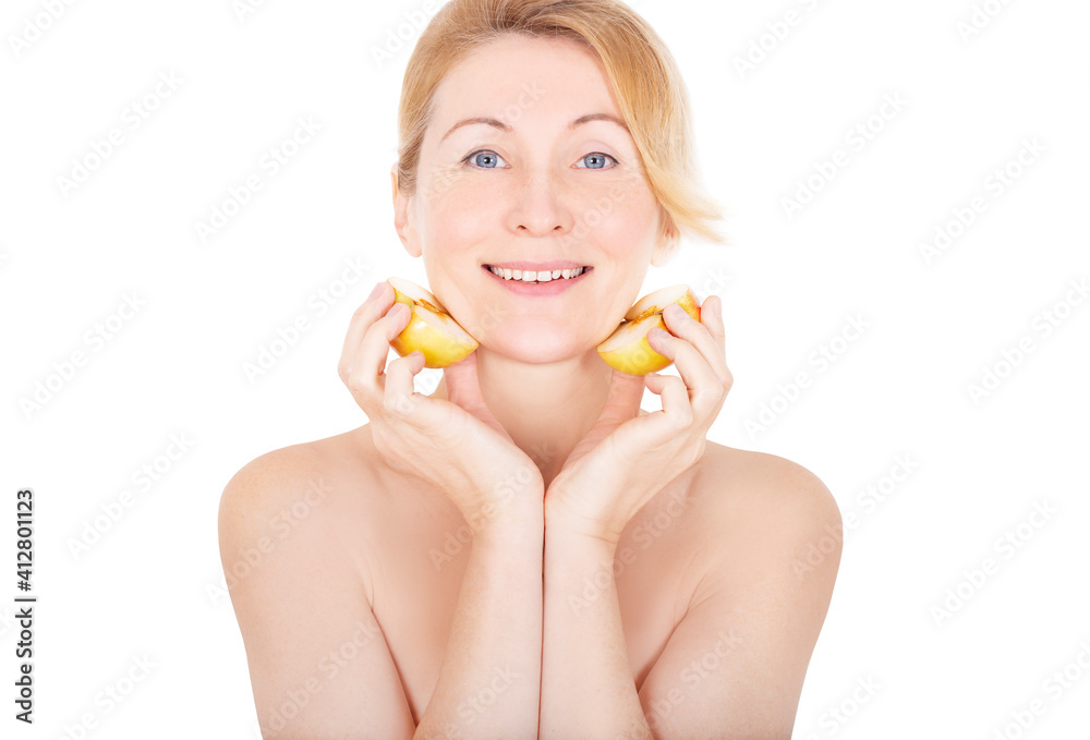 Woman moistens face with fresh apple halves Woman moistens face with fresh apple halves