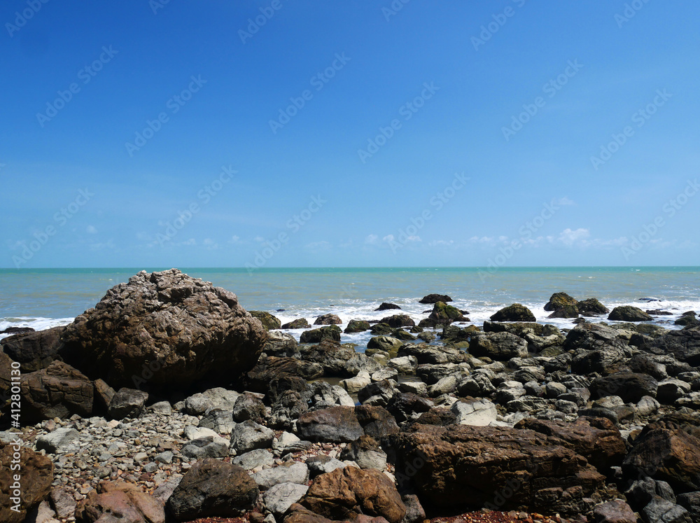 Beautiful seascape rock beach with blue sky