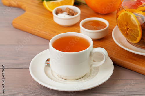 Cup of tea served with lemon and mint