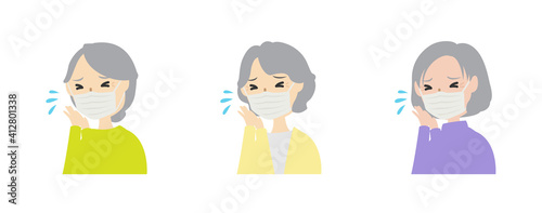マスクを着けてくしゃみしている女性高齢者たち
