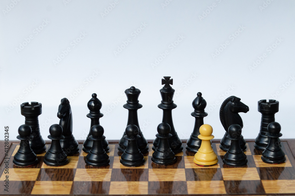 A foreing pawn in a chess set on a chess board A foreing pawn in a chess set on a chess board
