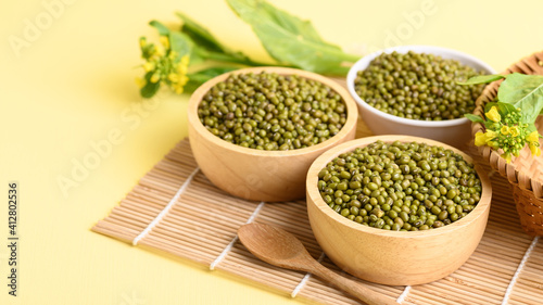 Dry green mung bean seeds in a wooden bowl, Food ingredients in Asian cuisine