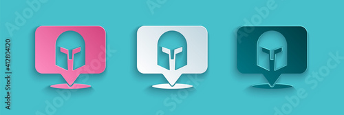 Paper cut Greek helmet icon isolated on blue background. Antiques helmet for head protection soldiers with a crest of feathers or horsehair. Paper art style. Vector.