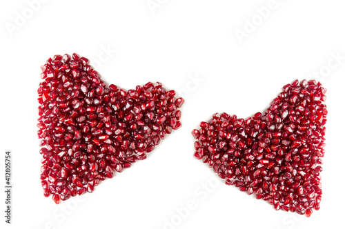 Heart from pomegranate seeds on a white background.