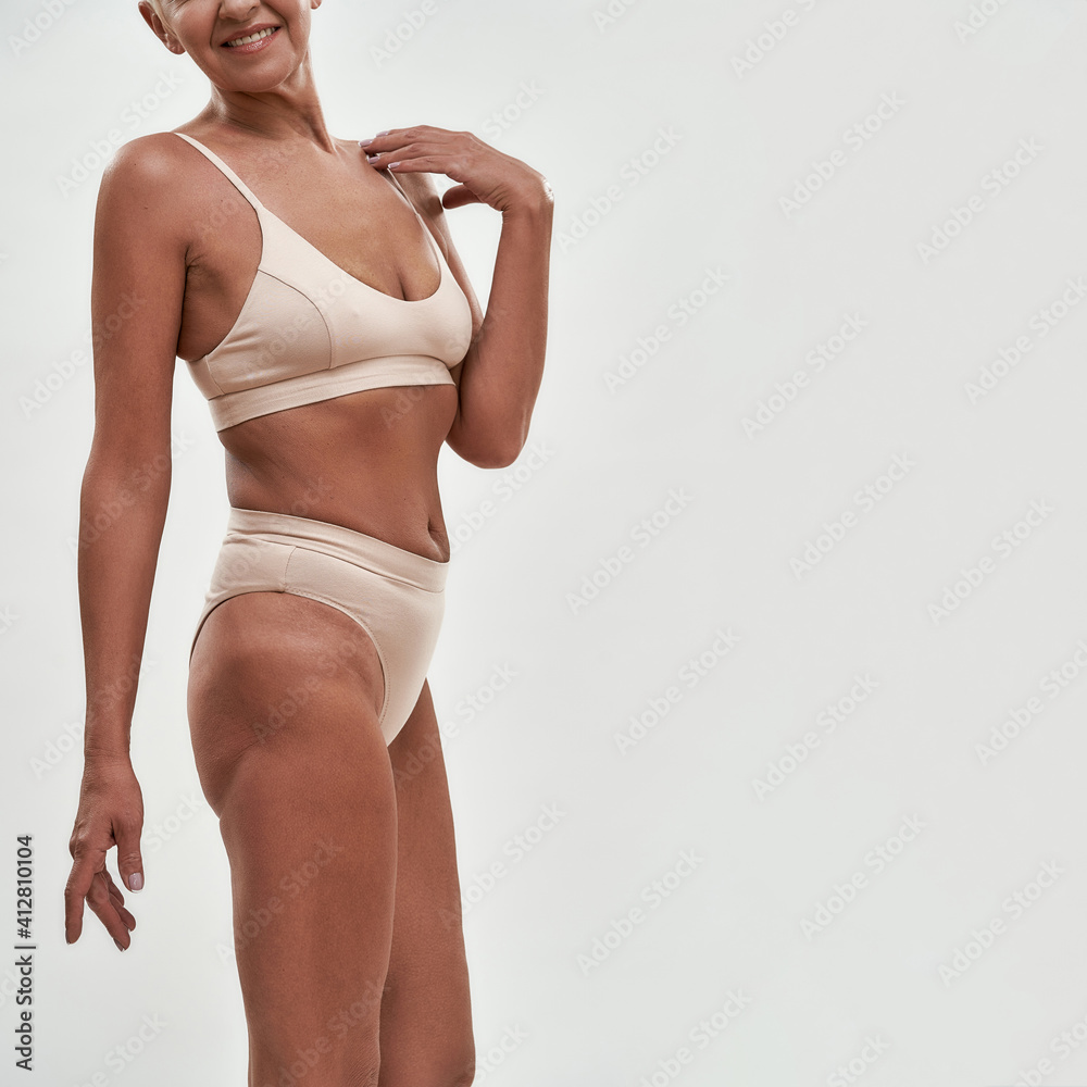 Happy middle aged woman in lingerie with slim figure