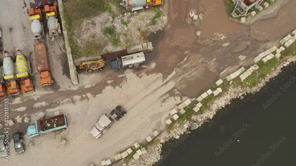Top down overhead aerial view of the truck without a trailer arriving at a maritime cargo port Top down overhead aerial view of the truck without a trailer arriving at a maritime cargo port