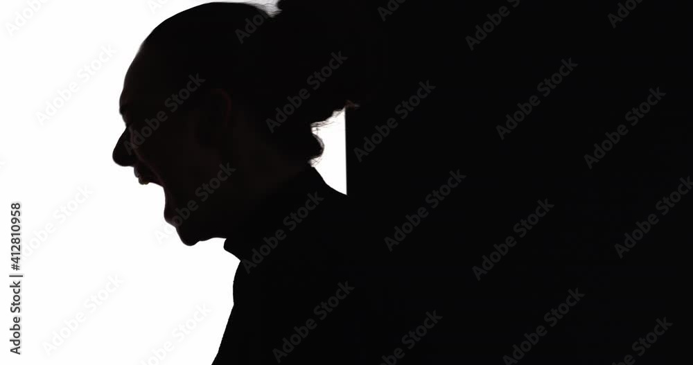 Female silhouette. Mental disorder. Nervous breakdown. Emotional crisis. Dark contrast profile shape of frustrated suffering hurt woman yelling isolated on white black empty space background. Female silhouette. Mental disorder. Nervous breakdown. Emotional crisis. Dark contrast profile shape of frustrated suffering hurt woman yelling isolated on white black empty space background.