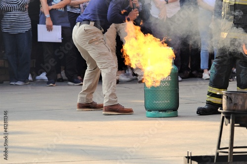 Firefighters are preparing fires to demonstrate how to extinguish fires at the annual fire drill, which is a mandatory law for the building owners.