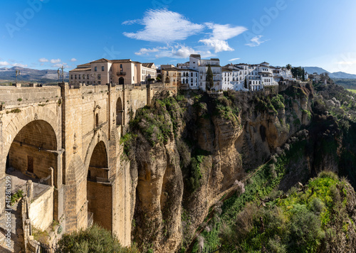 view of the old town of Ronda and the Puente Nuevo over El Tajo Gorge © makasana photo