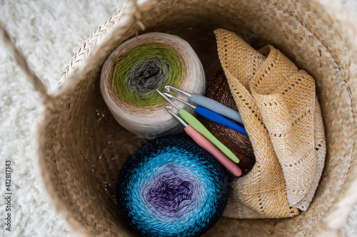 Clews of yarn and spokes in a textile bag. Female hobby. Closeup Fototapet