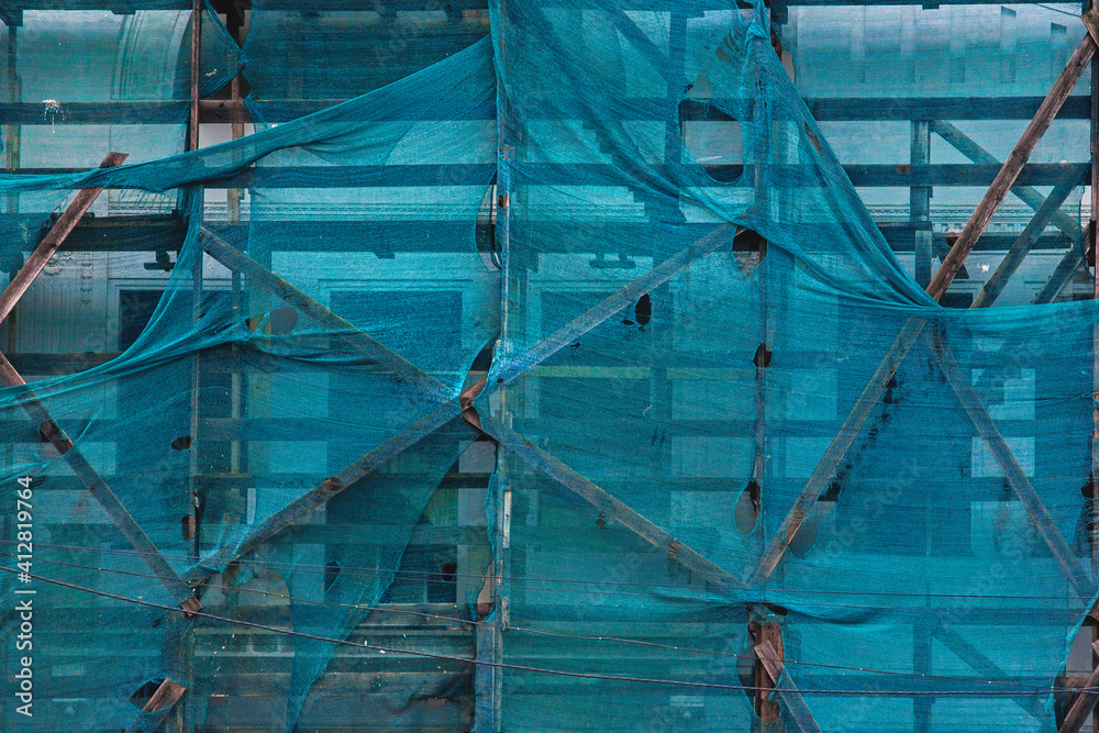 abstract mesh for masking construction site. Blue mesh on the construction site
