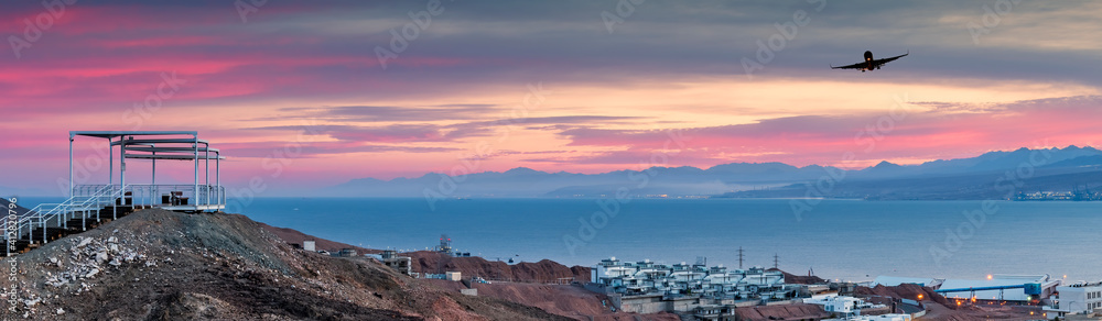 Scenic point of view on the Red Sea and mountains with decorative pergola and safe walkway to the stone summit in public park of Eilat - famous tourist resort and recreational city in Israel